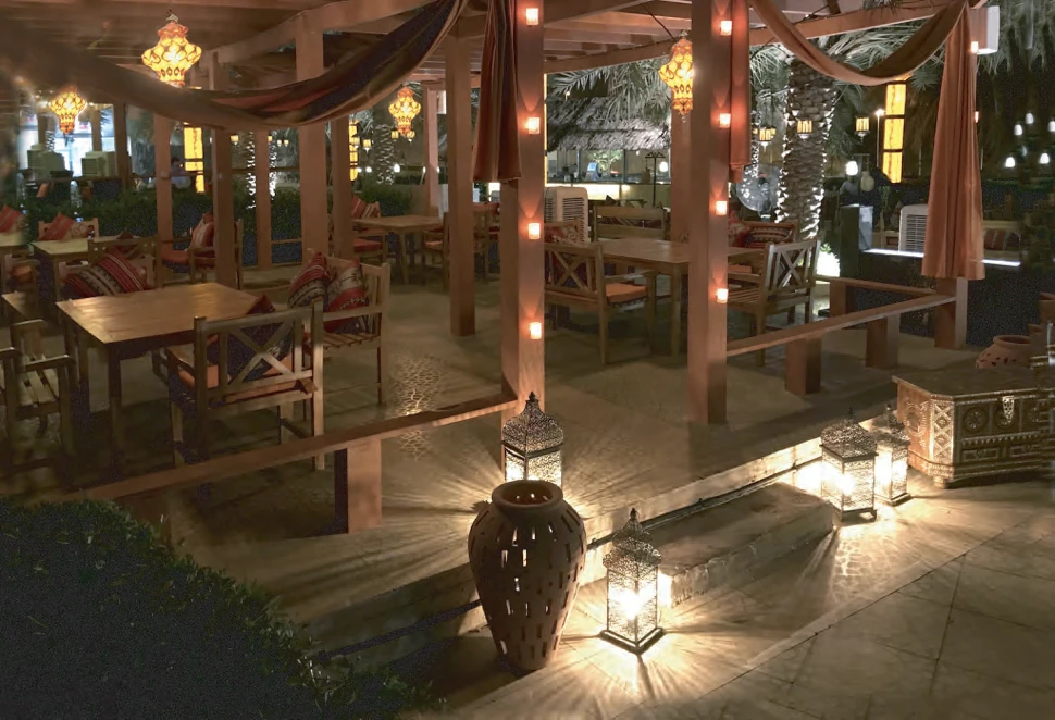 Lantern-lit outdoor terrace at Bait Al Shams in the evening
