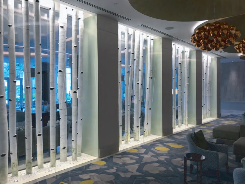 White birch-tree screen and copper-bubble chandelier in the Amwaj Lounge