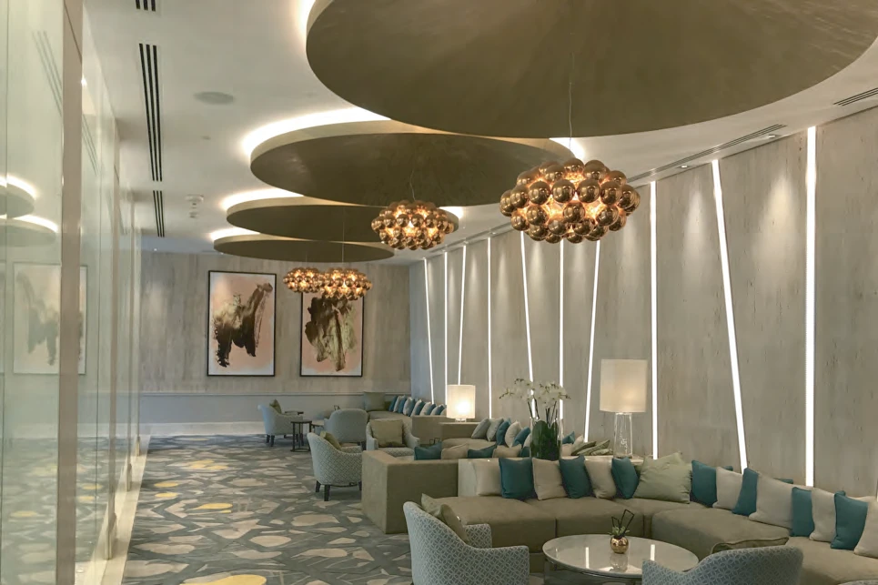 Large metallic canvases and copper-bubble chandeliers in the Amwaj Lounge