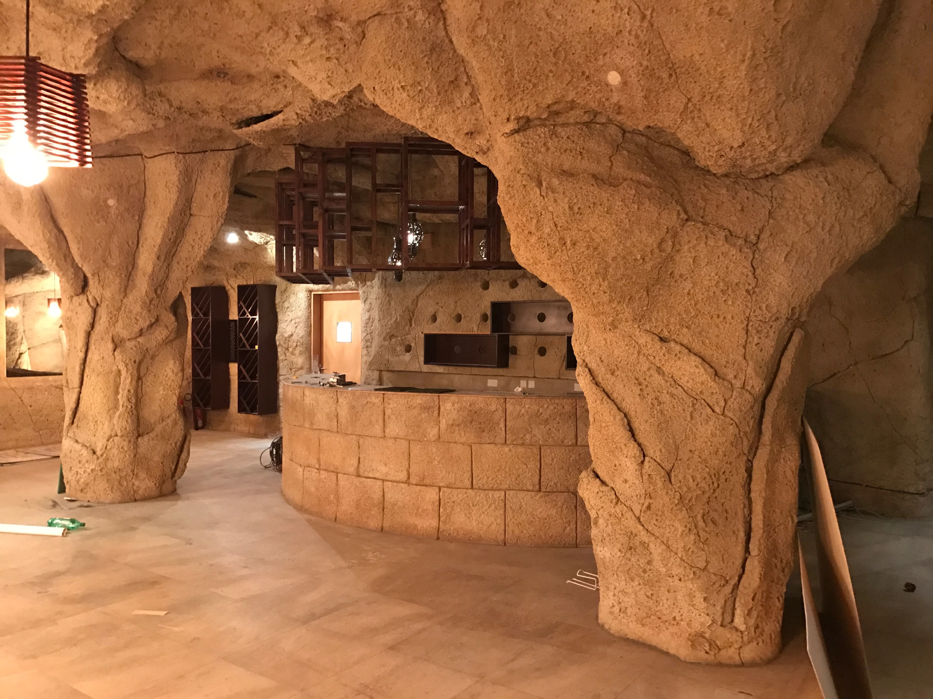 Cave-rock bar structure under construction at Monk's Tap House