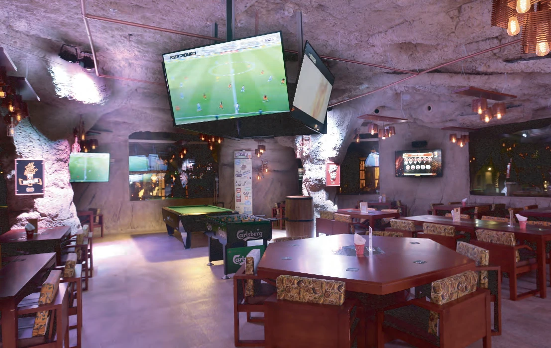 Sports-bar zone at Monk's Tap House with screens and a pool table