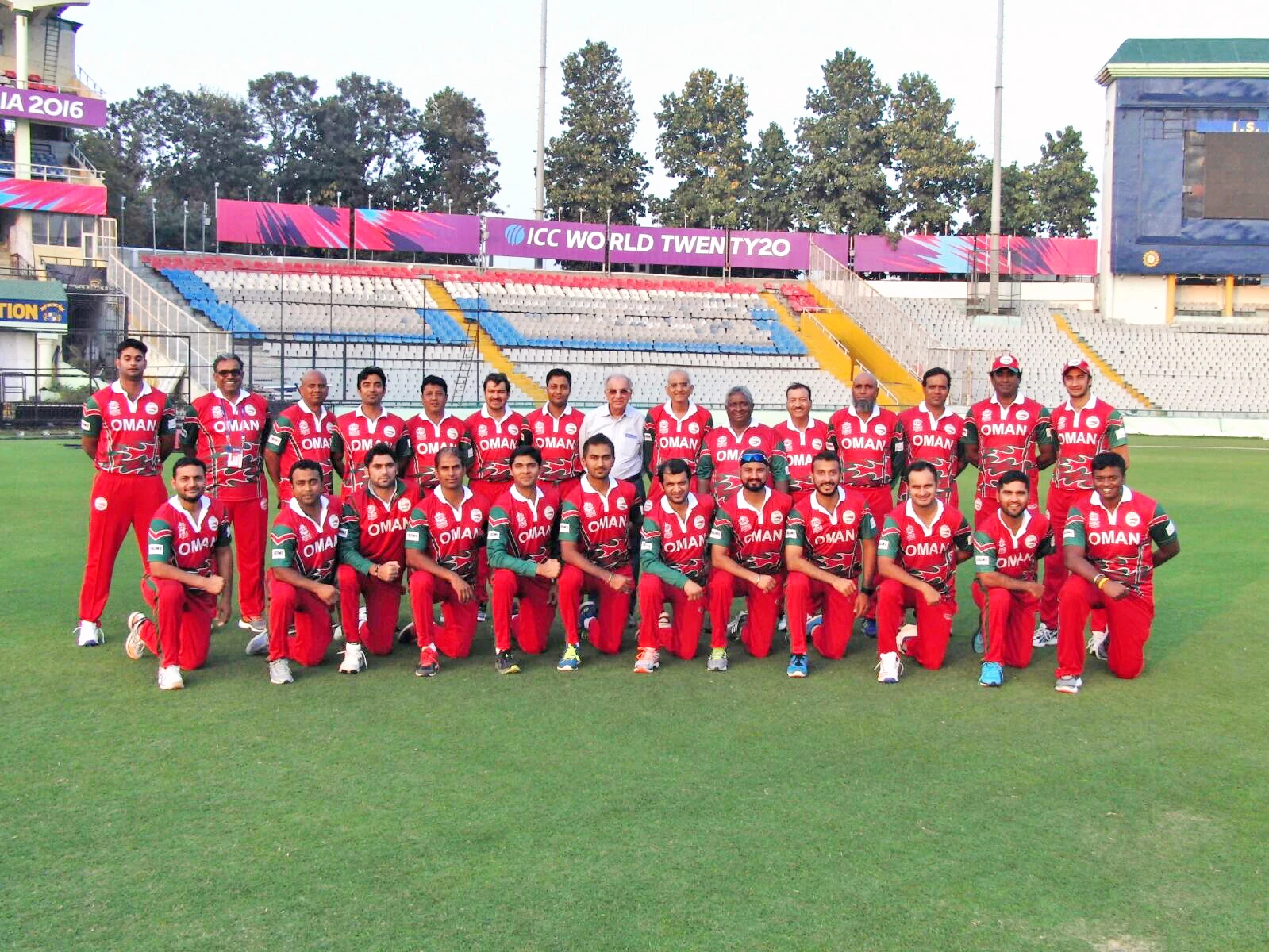 The Oman national cricket team squad in branded kit